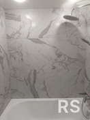 Укладка керамогранита на подготовленную поверхность, монтаж душевой системы, обработка швов.